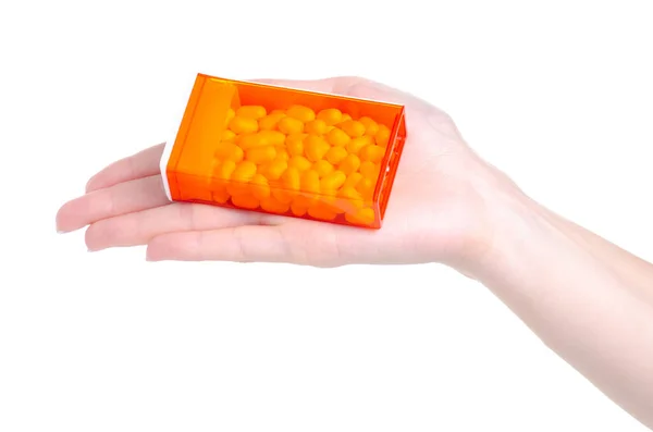 Elinde turuncu kabın içindeki Dragee — Stok fotoğraf