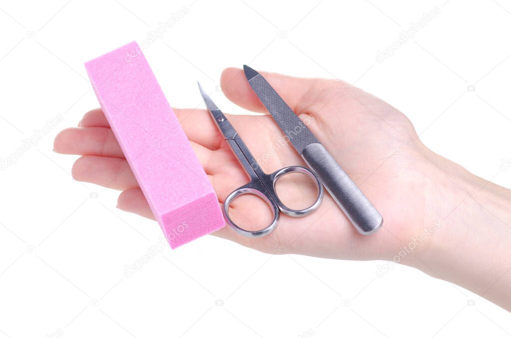Manicure nail file and scissors, buff in hand