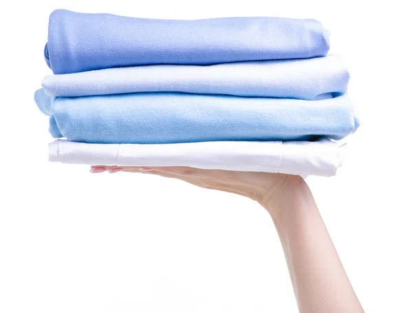 Pila de ropa plegada azul en la mano — Foto de Stock