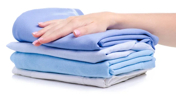 Pila de ropa plegada azul en la mano — Foto de Stock