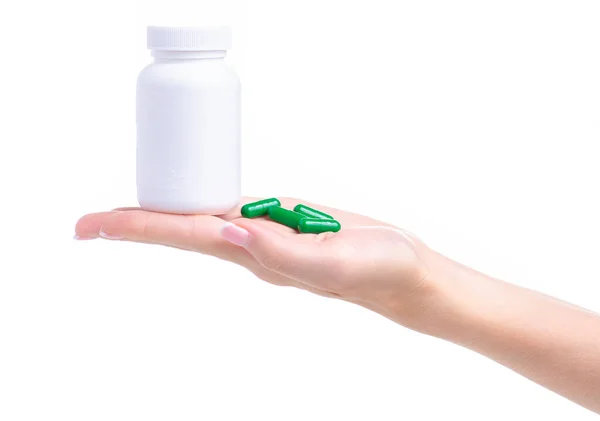 White jar of green pills capsule medicine pharmacy in hand — Stock Photo, Image