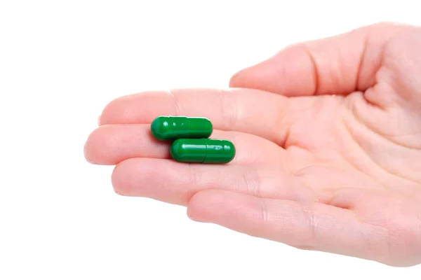 Pastillas verdes cápsula medicina farmacia en la mano — Foto de Stock