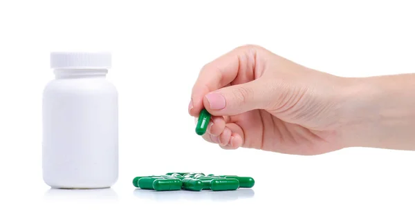 Vaso con pillole capsula verde medicina farmacia in mano — Foto Stock