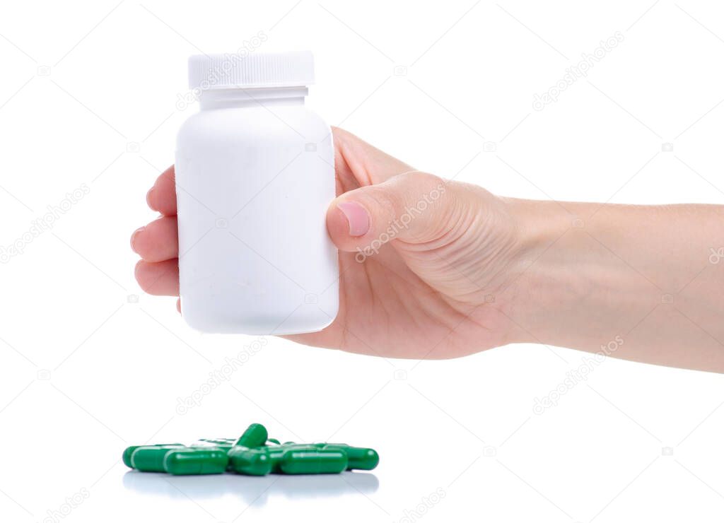 Jar with green capsule pills medicine pharmacy in hand