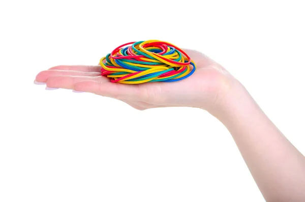 Канцелярские разноцветные резинки в руке — стоковое фото
