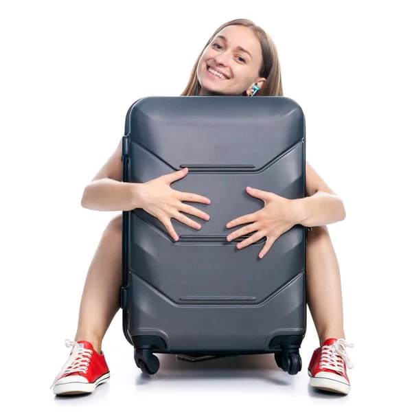 Woman with travel suitcase sitting waiting smiling — Stock Photo, Image