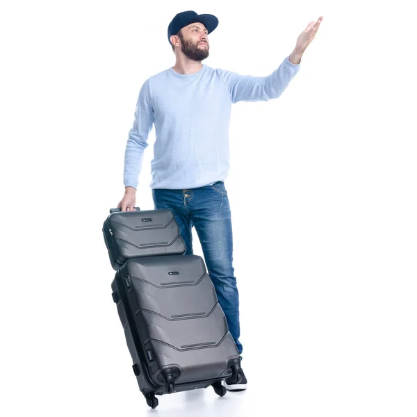 Man in jeans with travel suitcase standing showing pointing — Stock Photo, Image