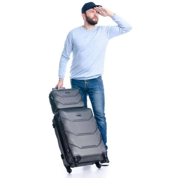 Mann in Jeans mit Reisekoffer schaut weg — Stockfoto