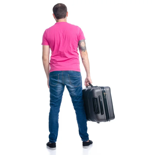 Mann in Jeans hält Reisekoffer im Stehen — Stockfoto