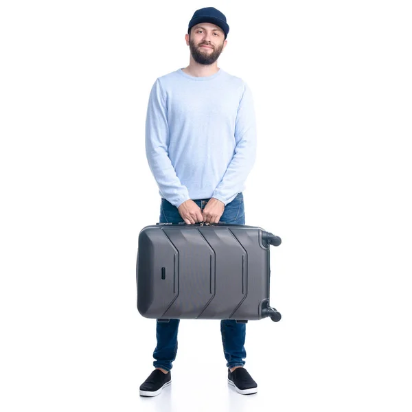 Homem de jeans segurando mala de viagem de pé — Fotografia de Stock