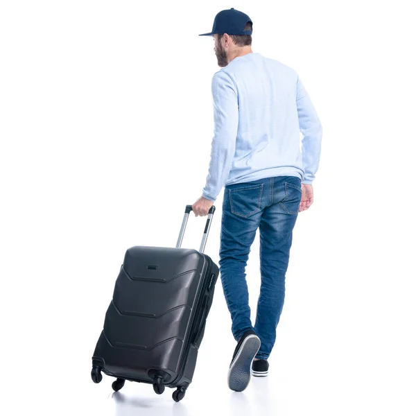 여행 가방을 든 청바지를 입은 남자는 걷기 시작 한다 — 스톡 사진