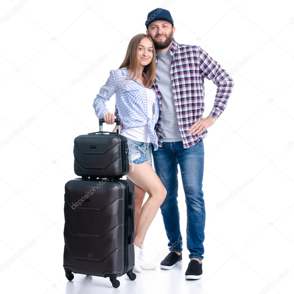 happy couple of tourists with black suitcase luggages smiling