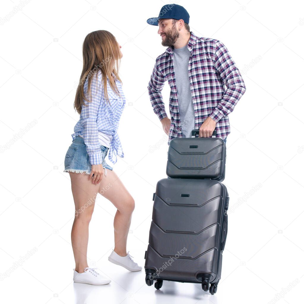 happy couple of tourists with black suitcase luggages smiling