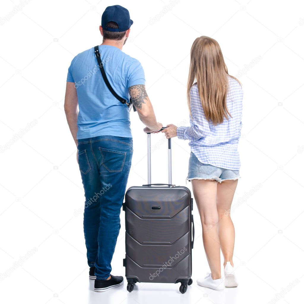 happy couple of tourists with black suitcase luggages smiling standing looking