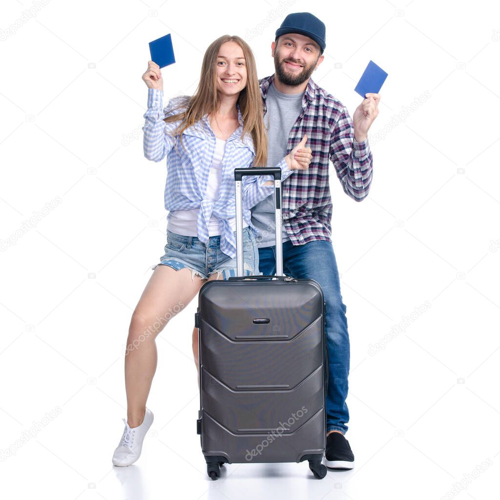 happy couple of tourists with black suitcase luggages smiling with passports