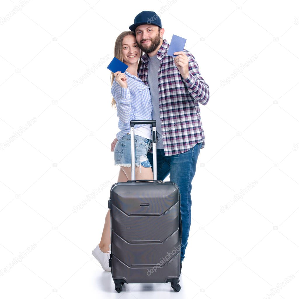 happy couple of tourists with black suitcase luggages smiling with passports