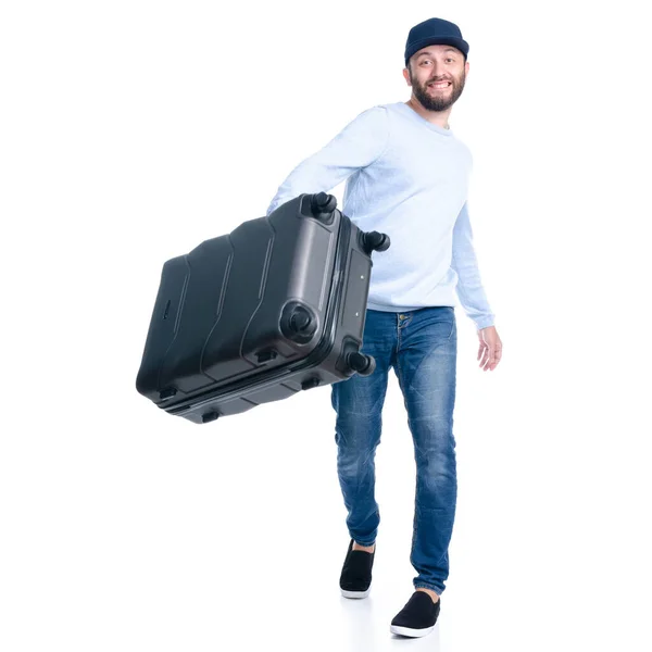 Man in jeans holding throws travel suitcase standing — Stock Photo, Image