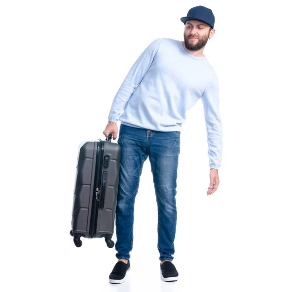 Homem de jeans segurando mala de viagem de pé — Fotografia de Stock