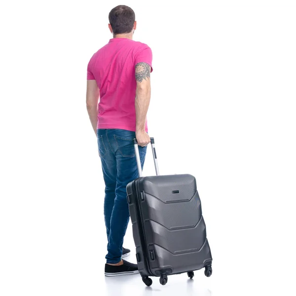 Homme en jeans avec valise de voyage debout — Photo