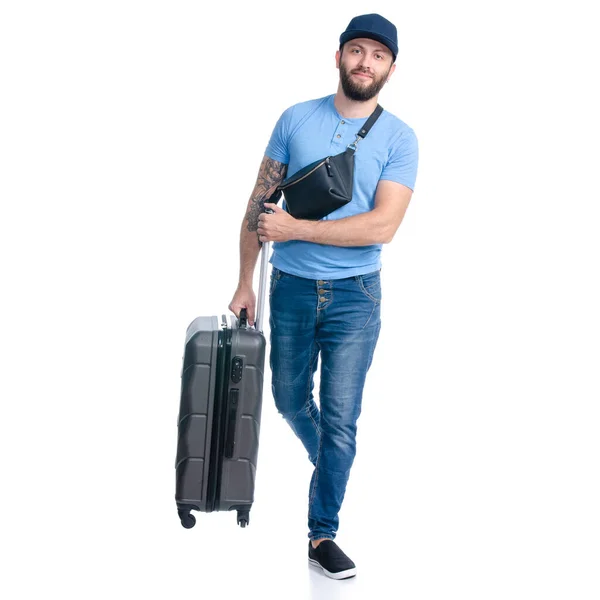 Człowiek w dżinsach z walizką podróżną idzie na spacer. — Zdjęcie stockowe