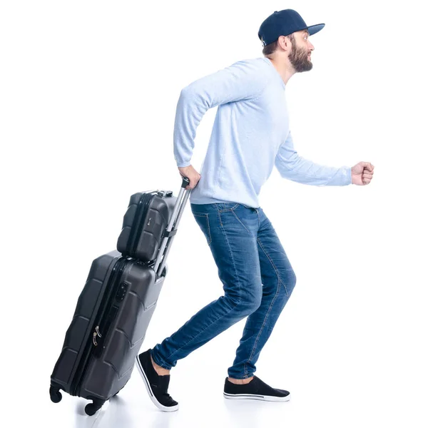 Uomo in jeans con valigia da viaggio va a camminare correndo — Foto Stock