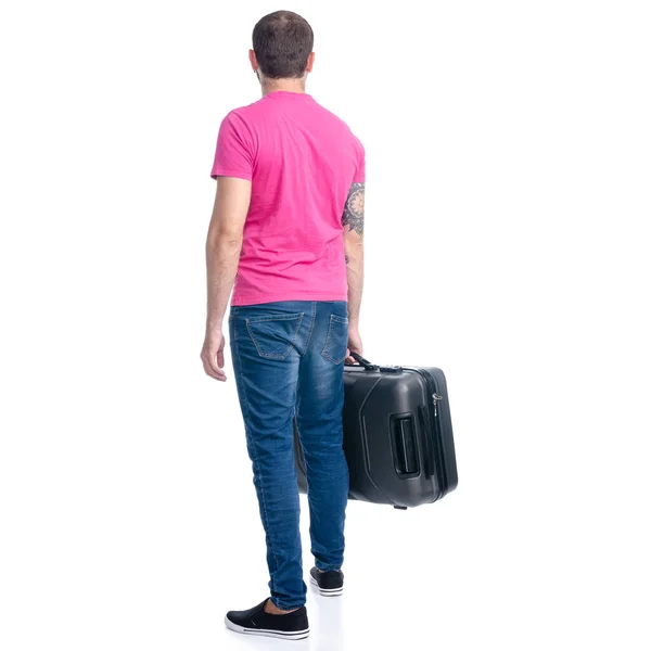 Mann in Jeans hält Reisekoffer im Stehen — Stockfoto