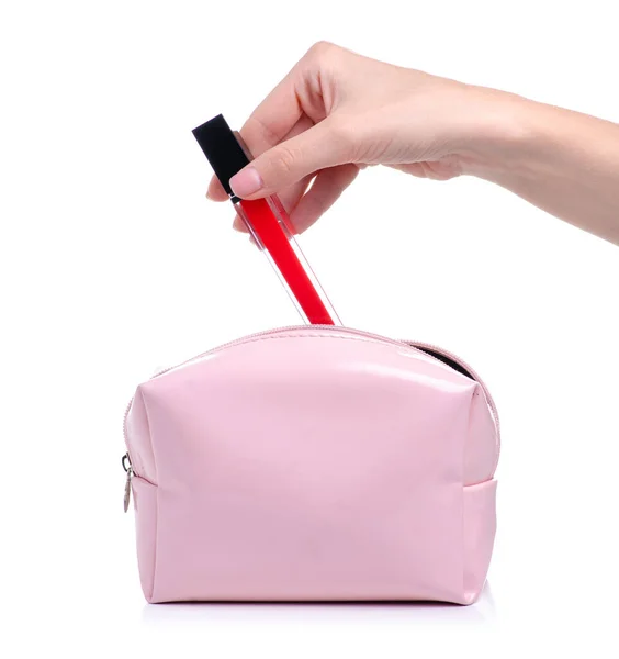 Red lip gloss beauty in hand put in cosmetic bag — Stock Photo, Image