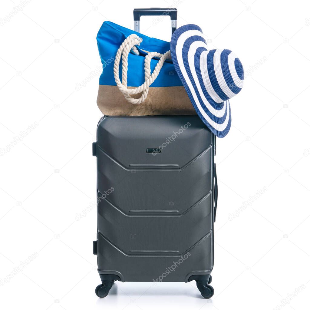 Summer holidays, vacation and travel concept. Suitcase, luggage with beach bag and straw hat