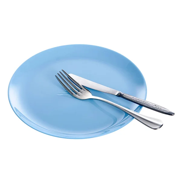 Синя тарілка з виделкою та ножем — стокове фото