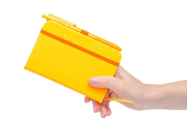 Narancssárga notebook napló tollal a kezében — Stock Fotó