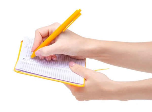 Дневник оранжевой тетради с ручкой в руке — стоковое фото