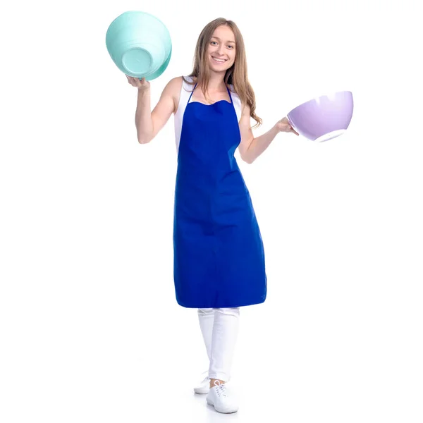 Nő kék kötényben, konyhai tálkával a kezében — Stock Fotó