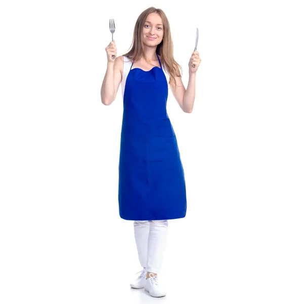 Mujer en delantal azul sonrisa sosteniendo tenedor y cuchillo en las manos —  Fotos de Stock