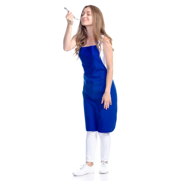 Donna in grembiule blu sorriso tenendo forchetta in mano — Foto Stock