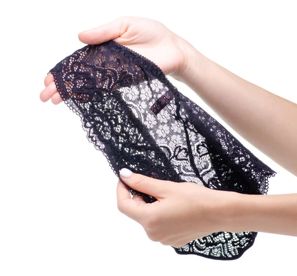 Kvinnliga svarta spets trosor i handen — Stockfoto