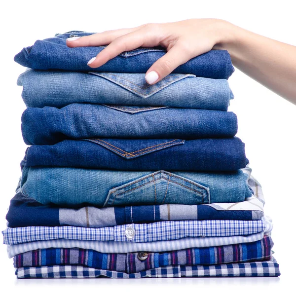 Stack folded casual shirt and jeans holding hand — Stock Photo, Image