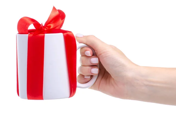 Taza de taza blanca con regalo de lazo de cinta roja en la mano Imagen De Stock