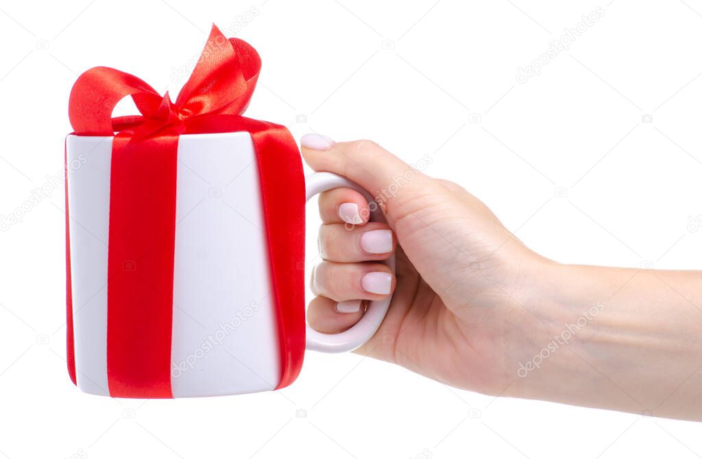 White cup mug with red ribbon bow gift in hand