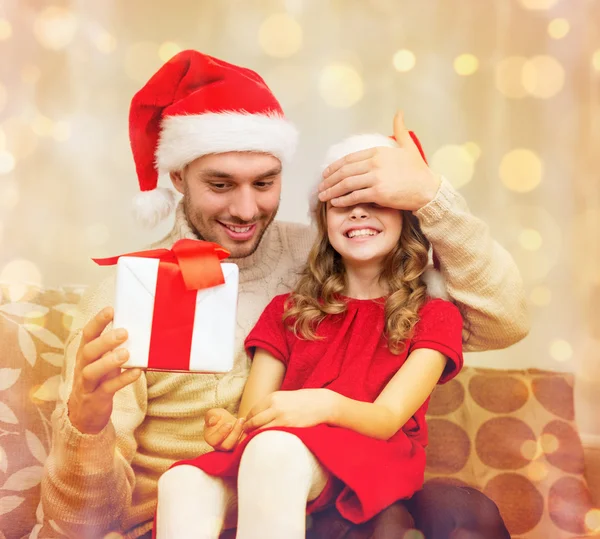 Smiling father surprises daughter with gift box — Stock Photo, Image