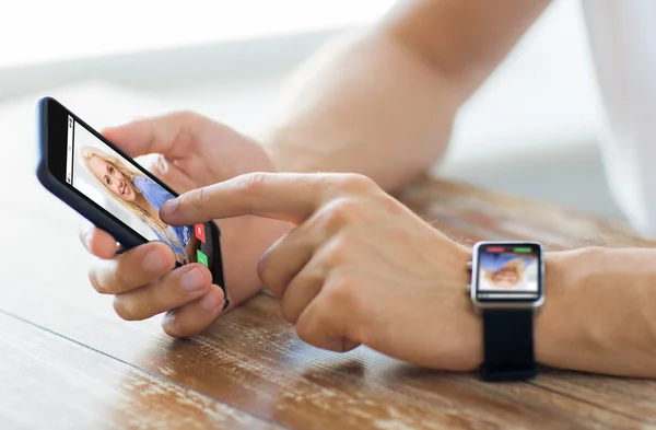 Close up of hands with smart phone and watch — Stock Photo, Image