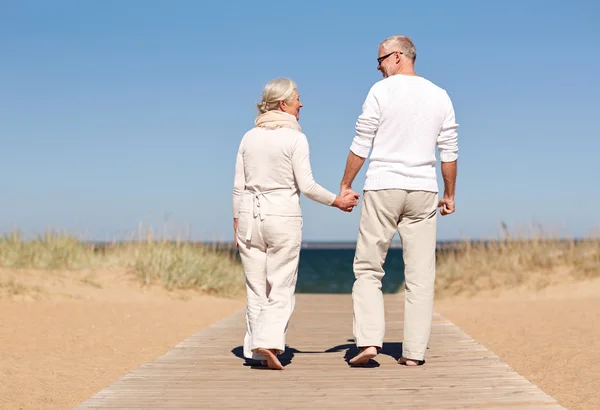 高级对幸福的夫妇手牵手在夏天的海滩上 — 图库照片