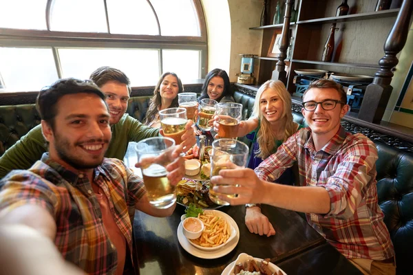 Happy friends taking selfie at bar or pub — Stock Photo, Image