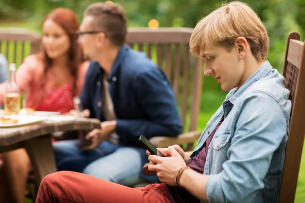 Człowiek z smartphone i przyjaciele summer party — Zdjęcie stockowe