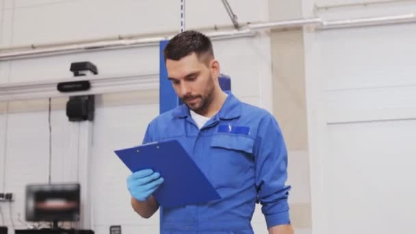 Mechaniker mit Schraubenschlüssel repariert Auto in Werkstatt 61 — Stockvideo