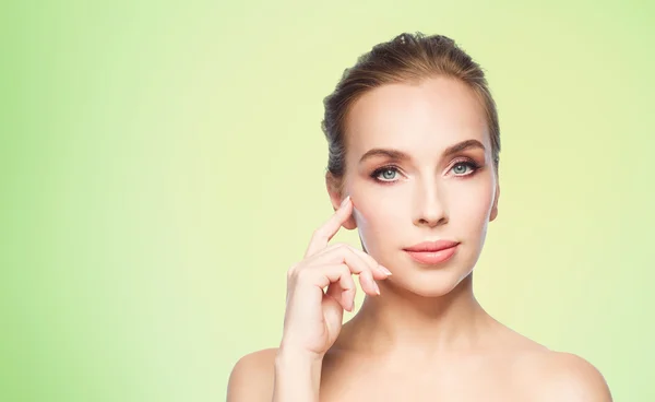 Beautiful young woman showing her cheekbone — Stock Photo, Image