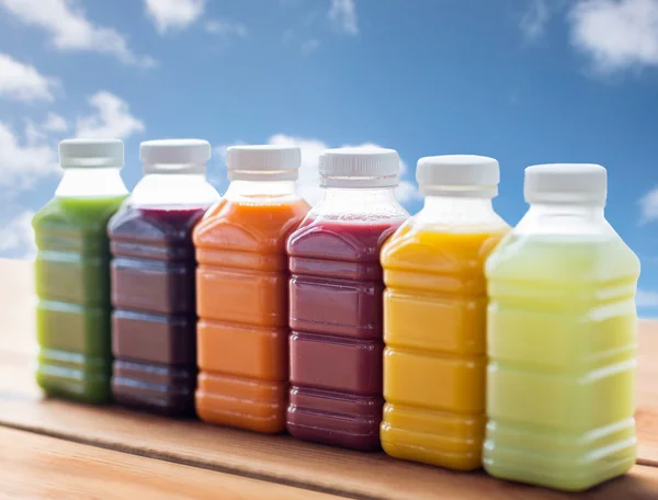 Bottles with different fruit or vegetable juices — Stock Photo, Image