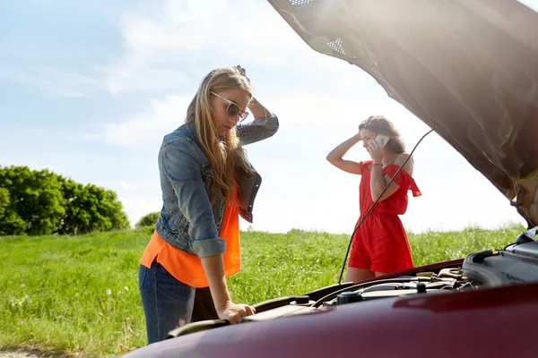 Mujeres con capucha abierta de coche roto en el campo — Foto de Stock