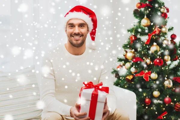 Glücklicher Mann mit Weihnachtsgeschenkschachtel zu Hause — Stockfoto
