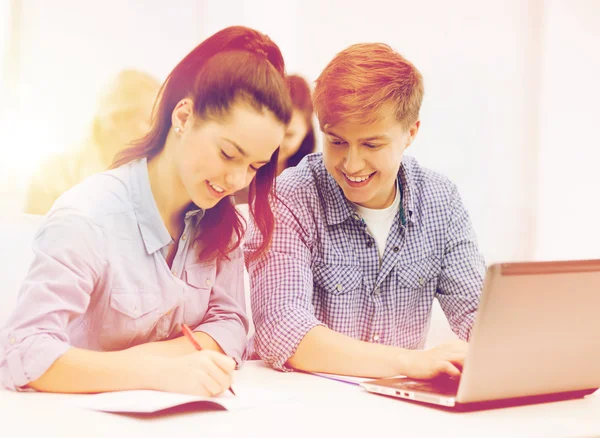 Students with laptop and notebooks at school — Stock Photo, Image