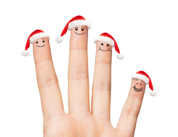 Close up of hand with four fingers in santa hats — Stock Photo, Image